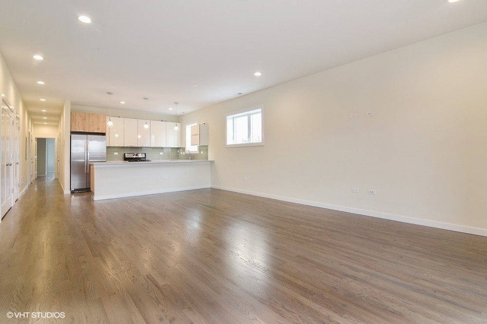 3326 West Irving Park Road, Unit 3E Chicago, IL 60618 - Photo 5 of 15 a view of a kitchen with a sink and wooden floor
