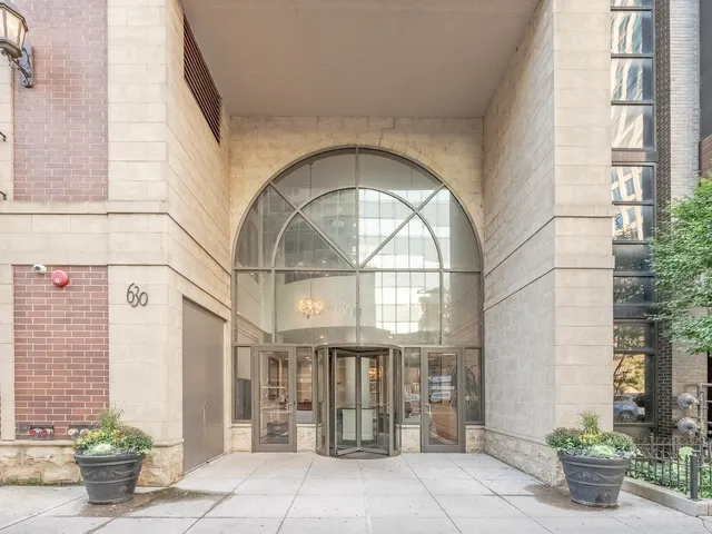 a front view of a building with potted plants