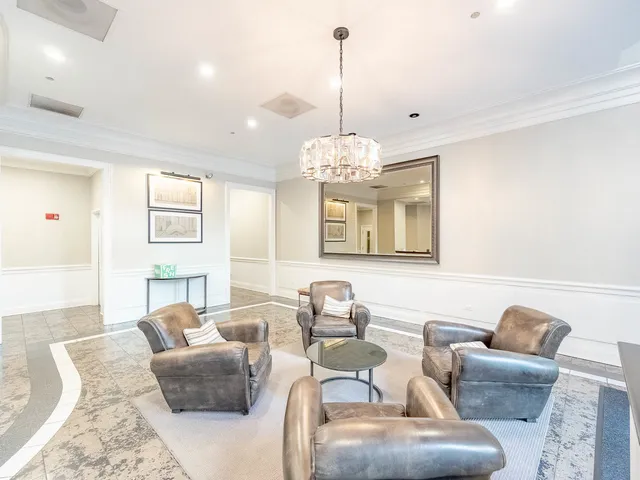 a living room with furniture chandelier and a view of kitchen