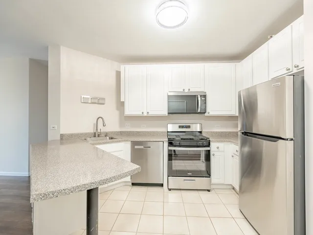 a kitchen with a sink a stove and refrigerator