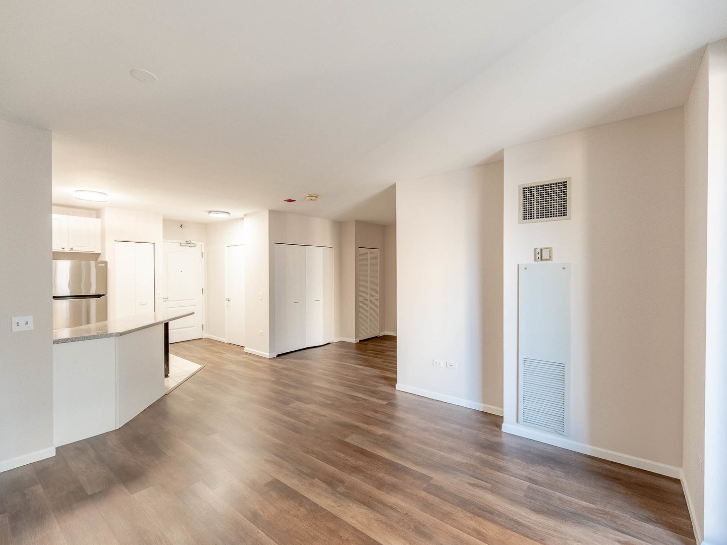 630 North State Street, Unit 2204 Chicago, IL 60654 - Photo 8 of 13 an empty room with wooden floor and windows