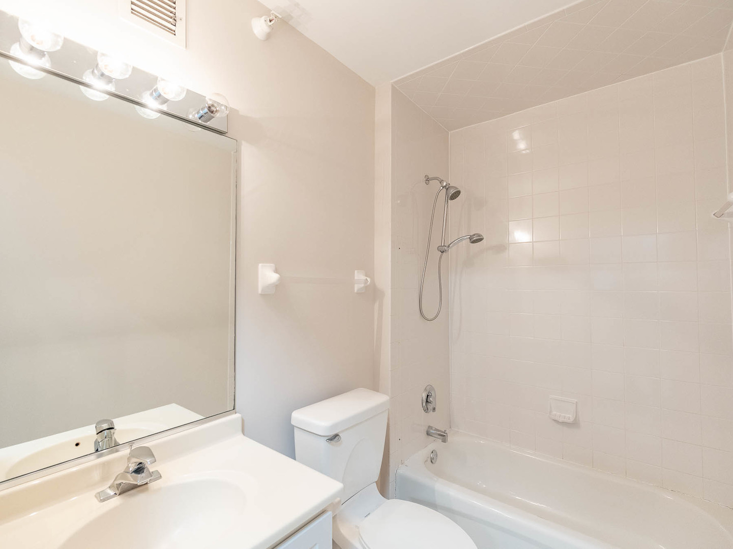 630 North State Street, Unit 2204 Chicago, IL 60654 - Photo 10 of 13 a bathroom with a bathtub shower sink vanity and toilet