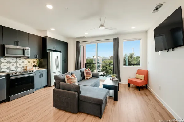 a living room with furniture and a flat screen tv