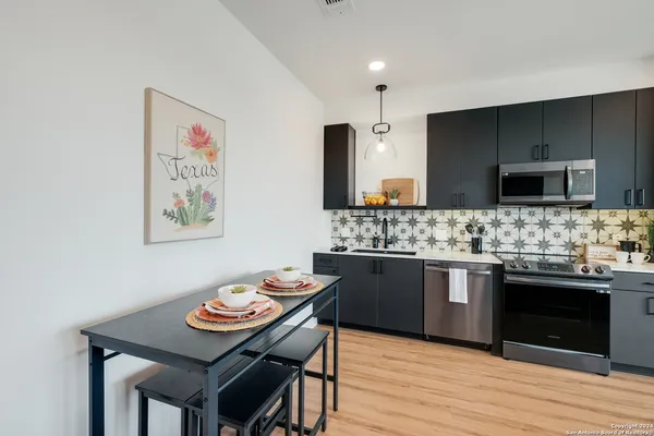 a kitchen with stainless steel appliances kitchen island granite countertop a sink and cabinets