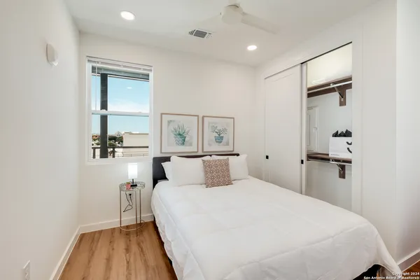 a bedroom with a bed and a night stand