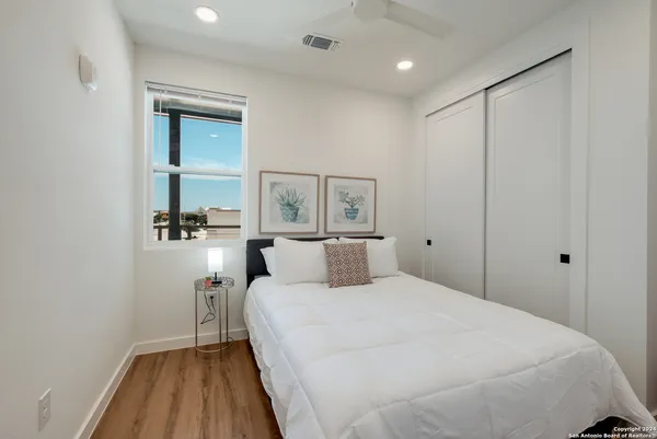 a bedroom with a bed and a mirror