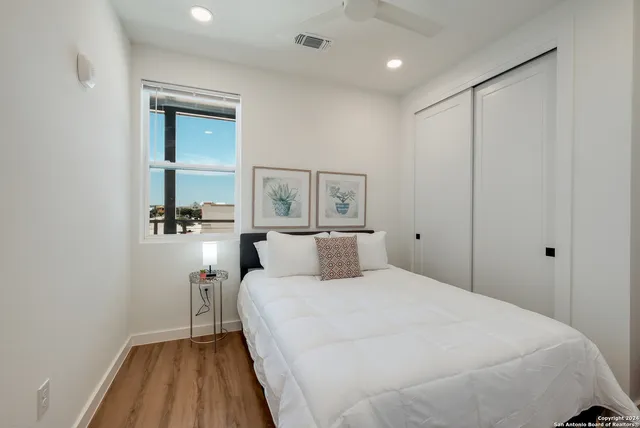 a bedroom with a bed and a mirror