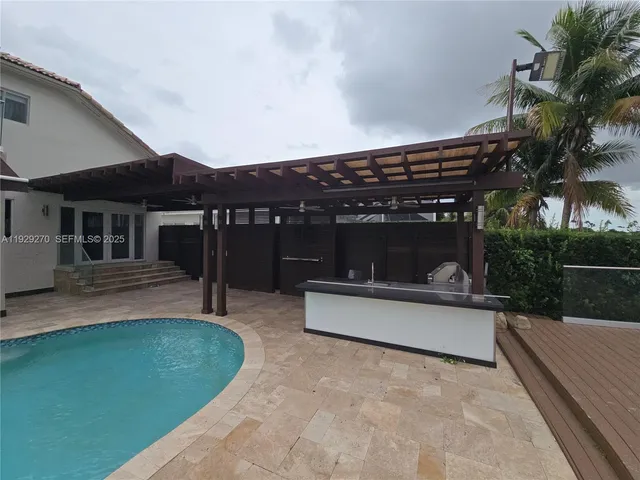 a view of a house with a patio and a yard