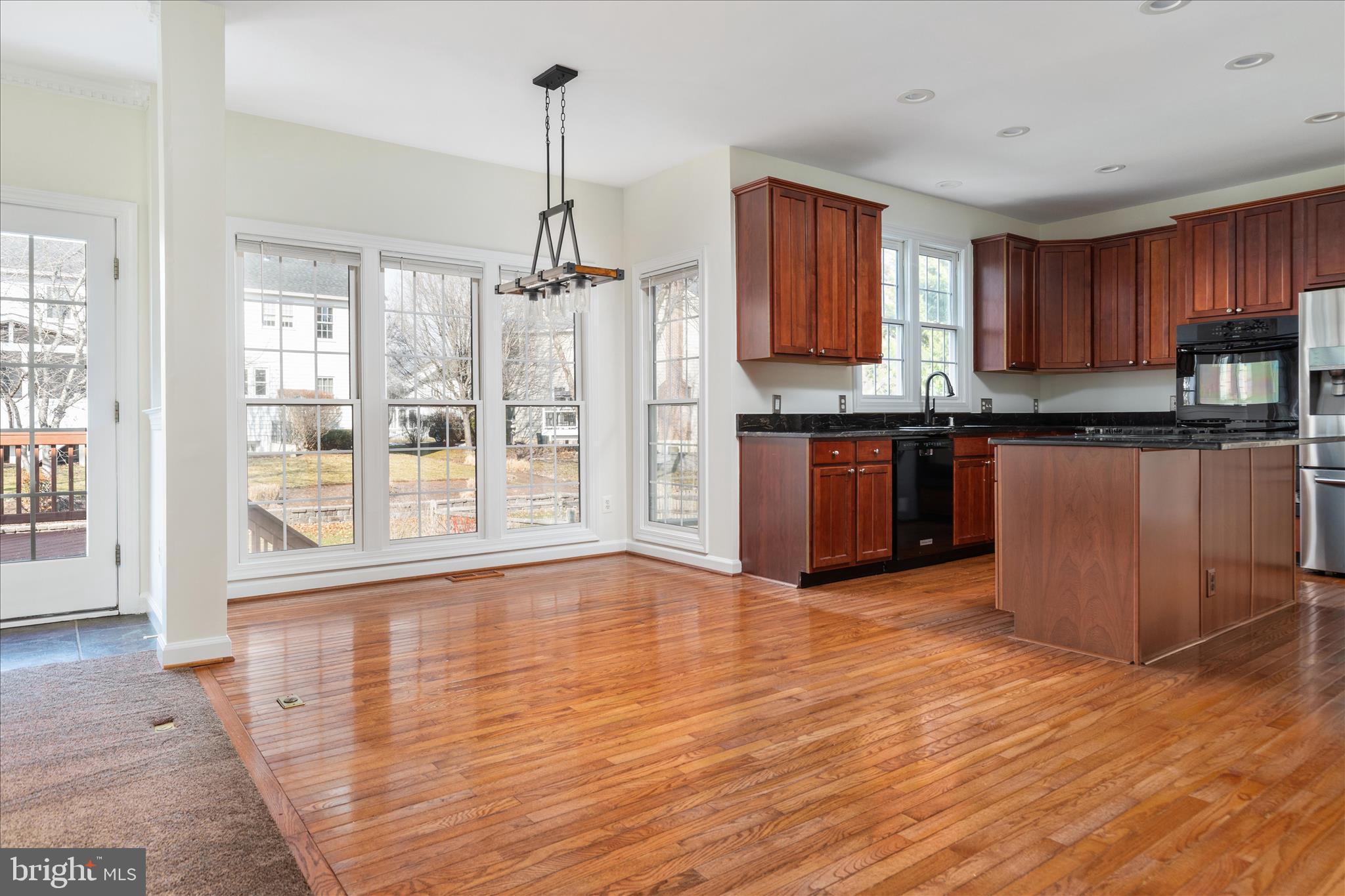 43331 Ritter Lane South Riding, VA 20152 - Photo 16 of 55 a open kitchen with granite countertop a stove top oven a sink with wooden floor and cabinets