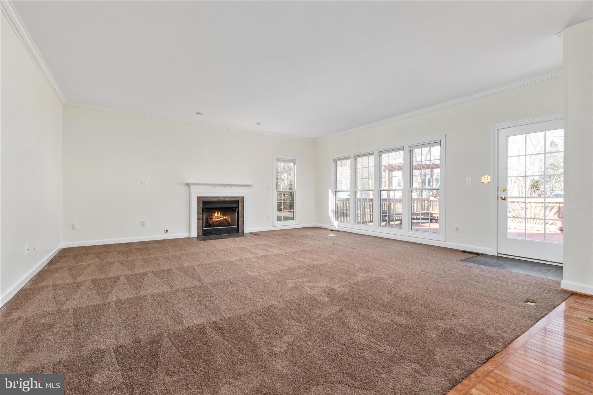 43331 Ritter Lane South Riding, VA 20152 - Photo 18 of 55 an empty room with fireplace and wooden floor
