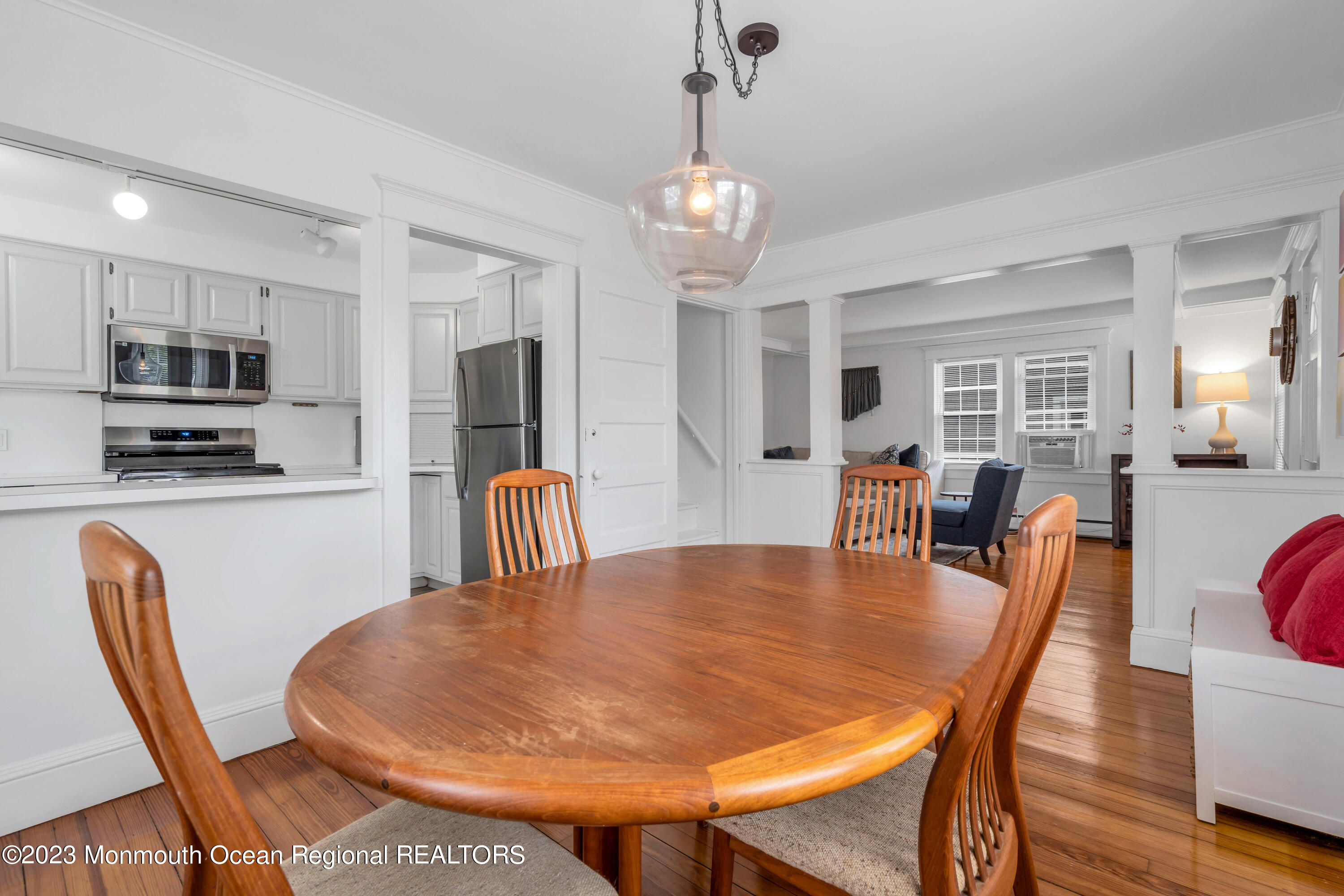 1107 5th Avenue Spring Lake, NJ 07762 - Photo 13 of 38 a dining room with furniture a chandelier and wooden floor