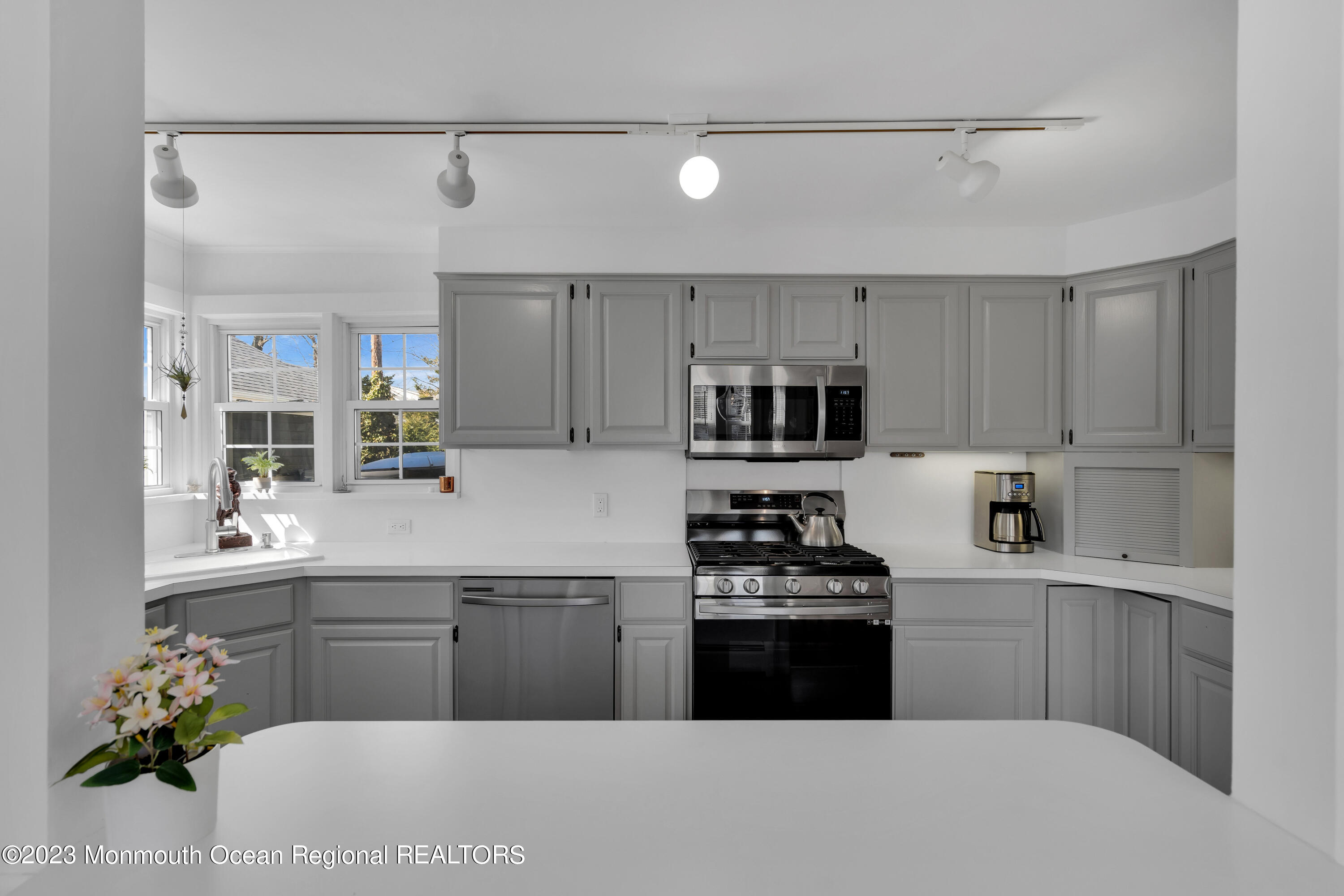 1107 5th Avenue Spring Lake, NJ 07762 - Photo 16 of 38 a kitchen with kitchen island white cabinets appliances and a counter top