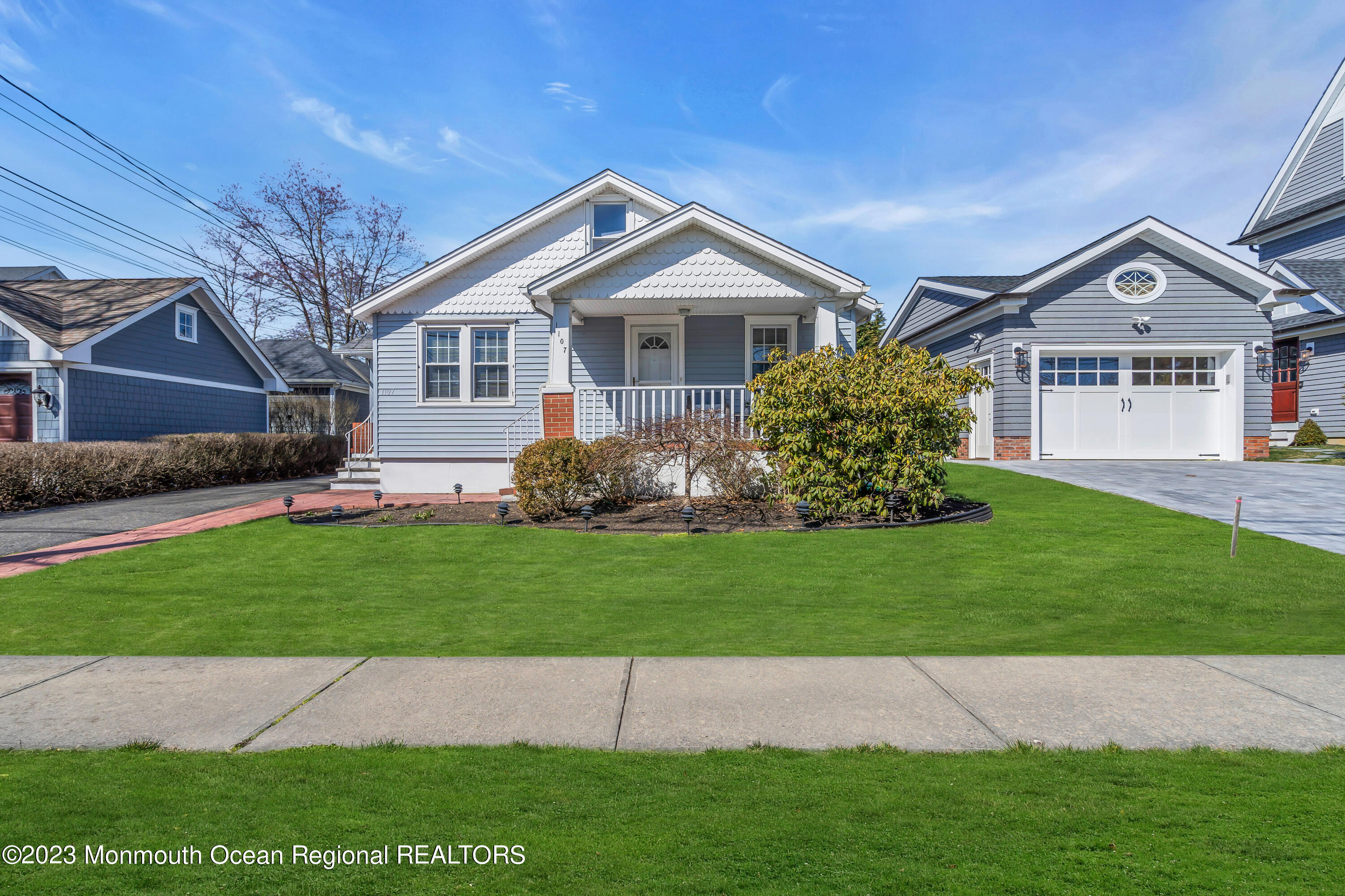 1107 5th Avenue Spring Lake, NJ 07762 - Photo 2 of 38 a front view of a house with a garden