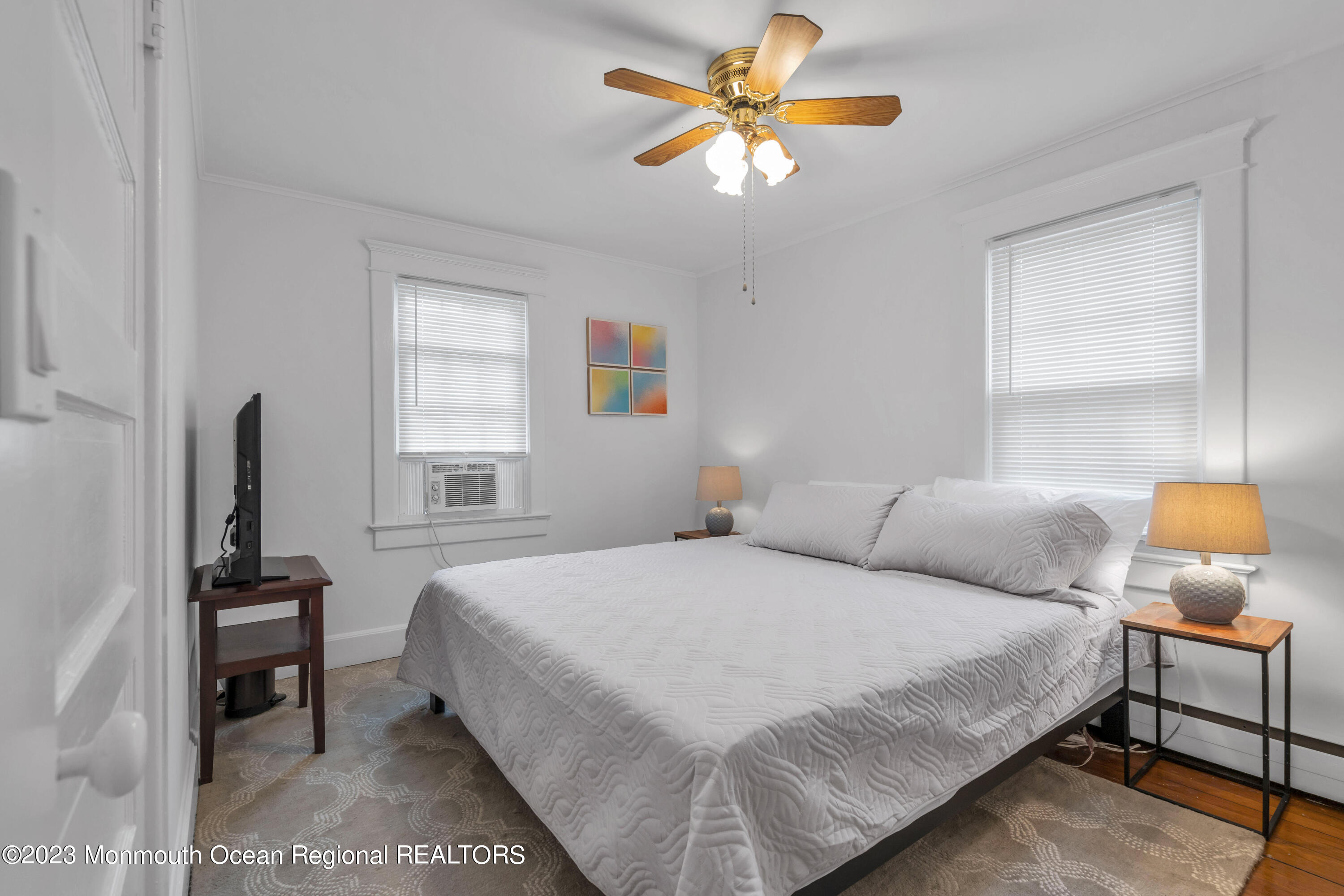 1107 5th Avenue Spring Lake, NJ 07762 - Photo 23 of 38 a bedroom with a bed and a chandelier
