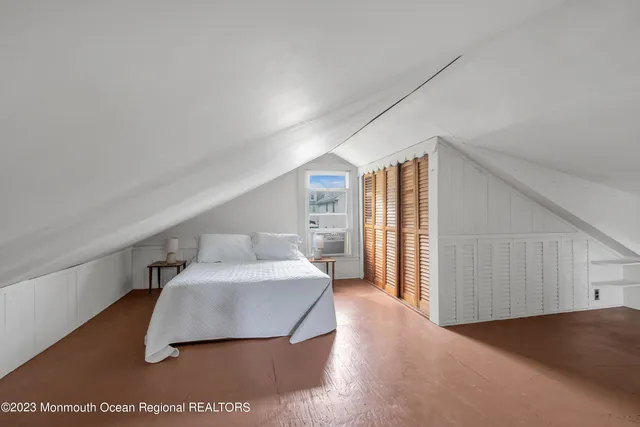 a hallway with a large window and dresser