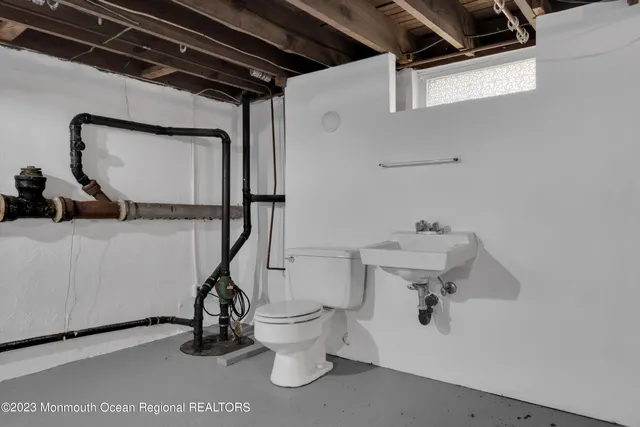 a bathroom with a sink a toilet and mirror