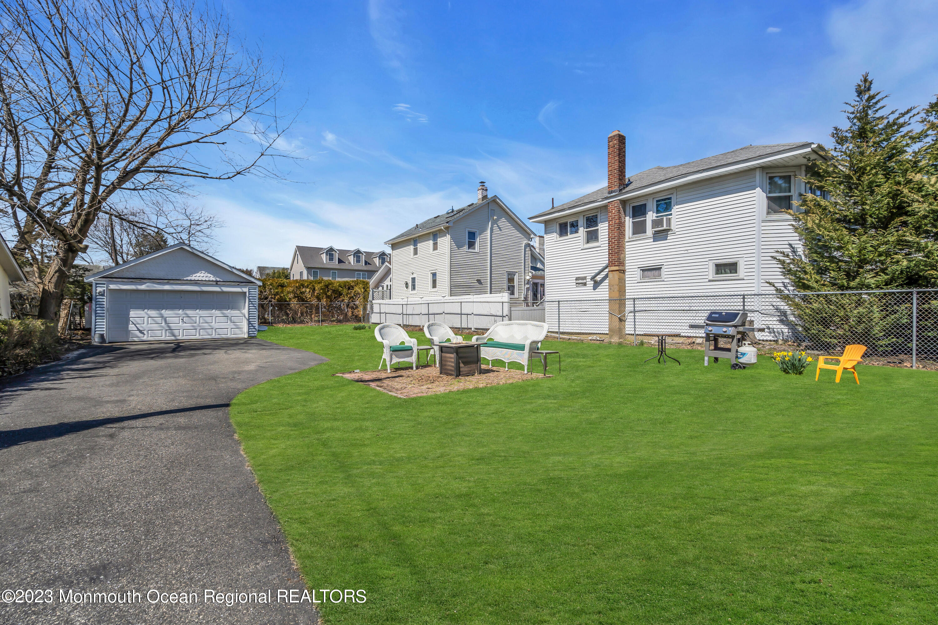 1107 5th Avenue Spring Lake, NJ 07762 - Photo 34 of 38 a front view of a house with a yard and trees