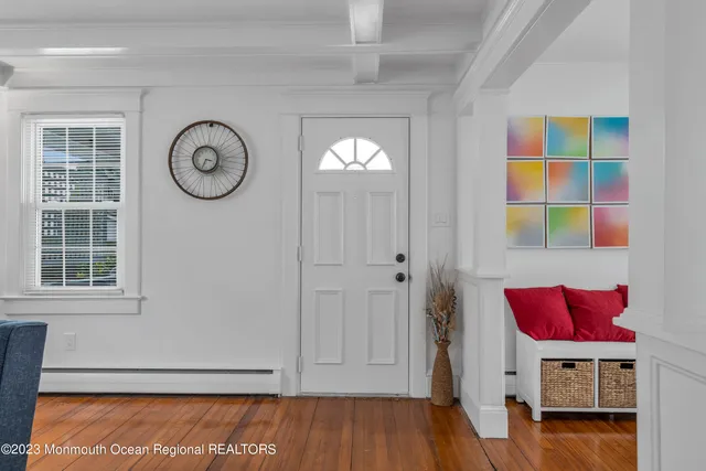 a view of a room with wooden floor and window