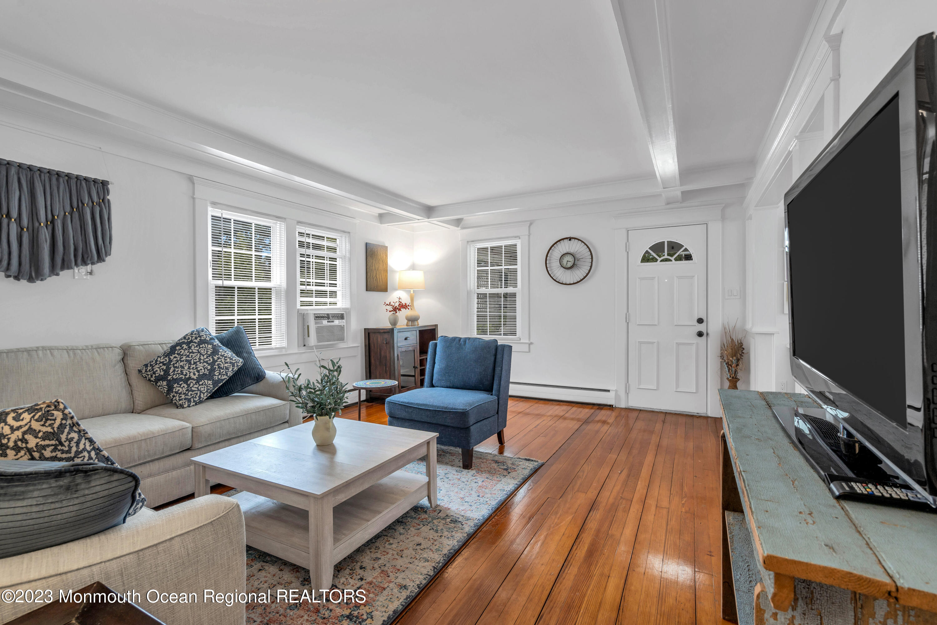 1107 5th Avenue Spring Lake, NJ 07762 - Photo 7 of 38 a living room with furniture a flat screen tv and a window