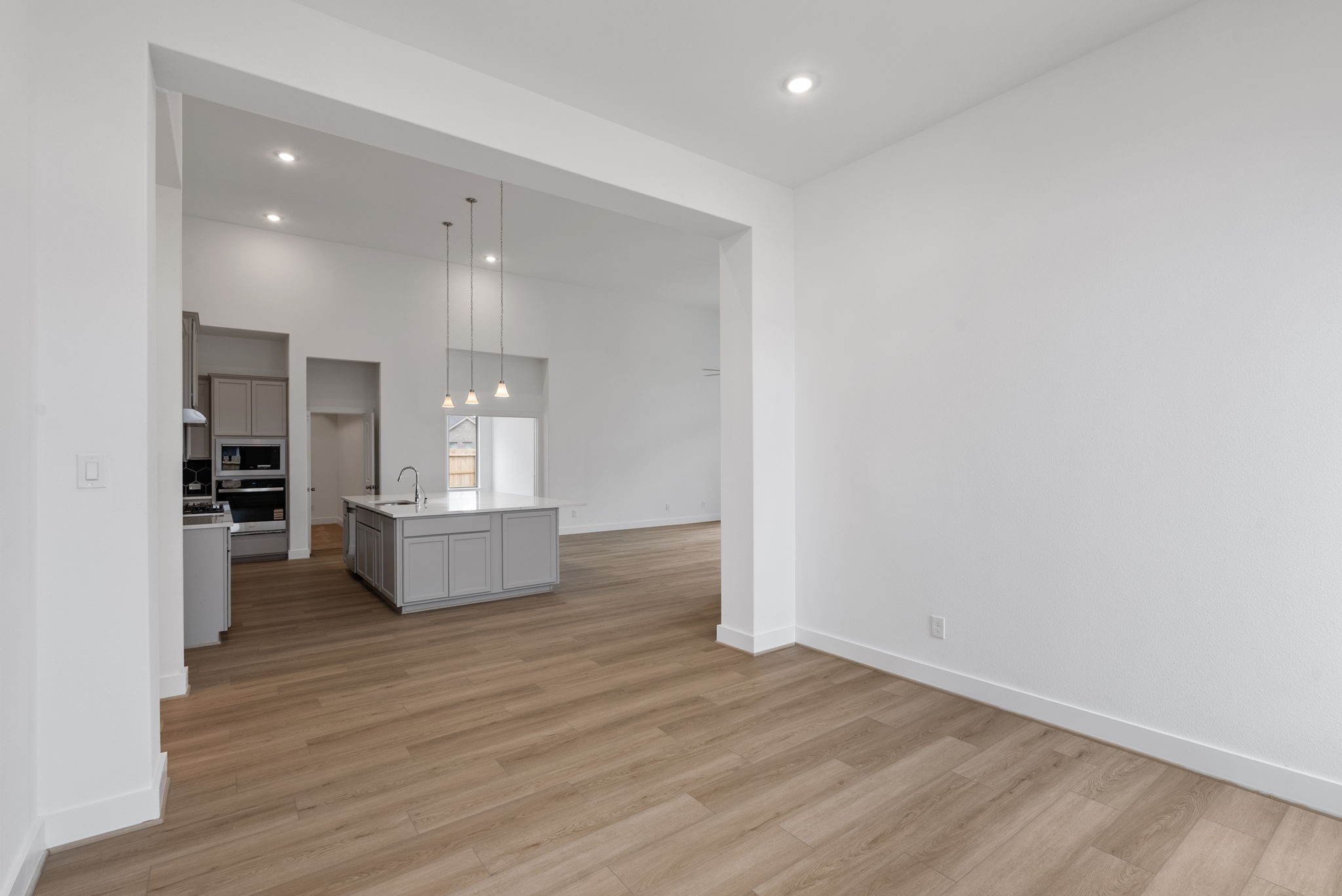 18806 Forested Street Manvel, TX 77578 - Photo 12 of 35 a view of kitchen and hall with wooden floor