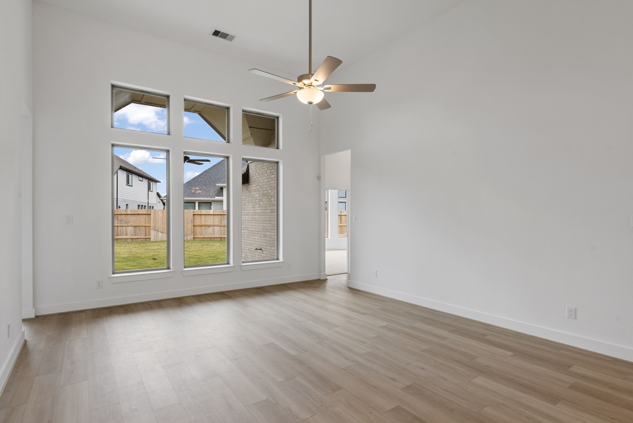 18806 Forested Street Manvel, TX 77578 - Photo 13 of 35 a view of a room with wooden floor chandelier and windows