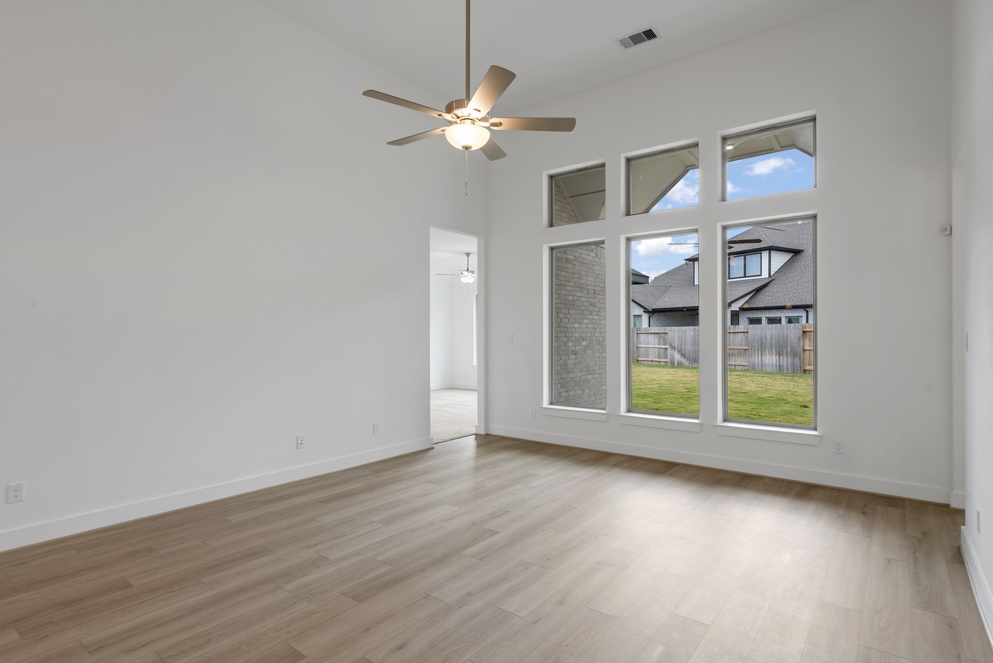 18806 Forested Street Manvel, TX 77578 - Photo 14 of 35 an empty room with wooden floor fan and window