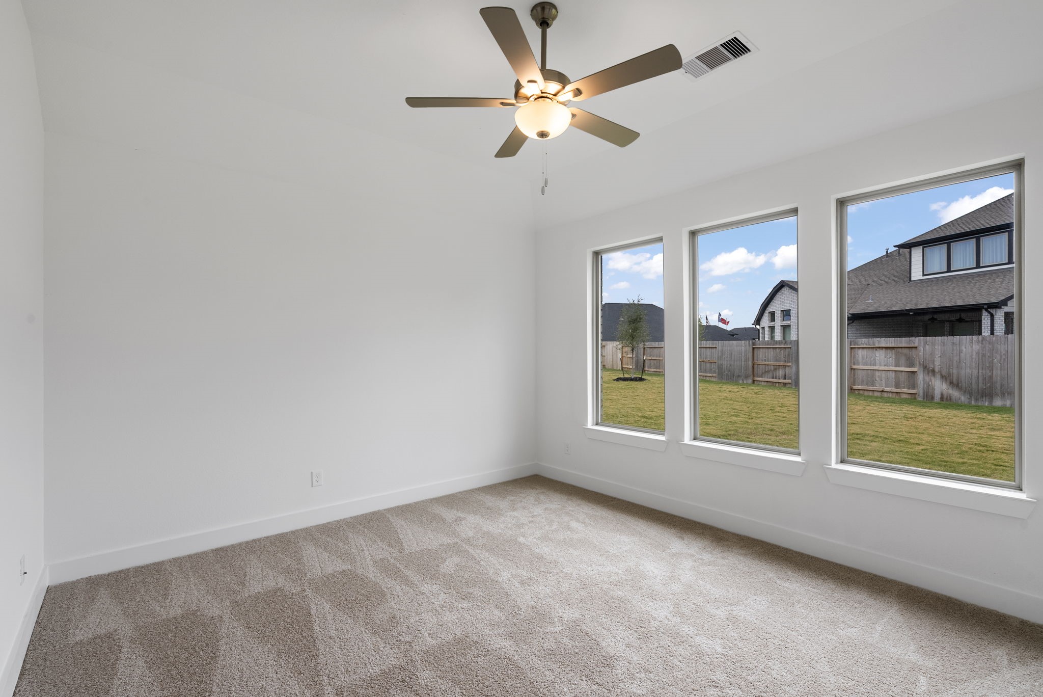 18806 Forested Street Manvel, TX 77578 - Photo 16 of 35 an empty room with windows and fan
