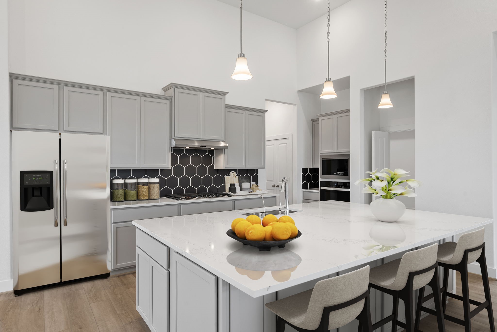 18806 Forested Street Manvel, TX 77578 - Photo 2 of 35 a kitchen with a sink a refrigerator and chairs