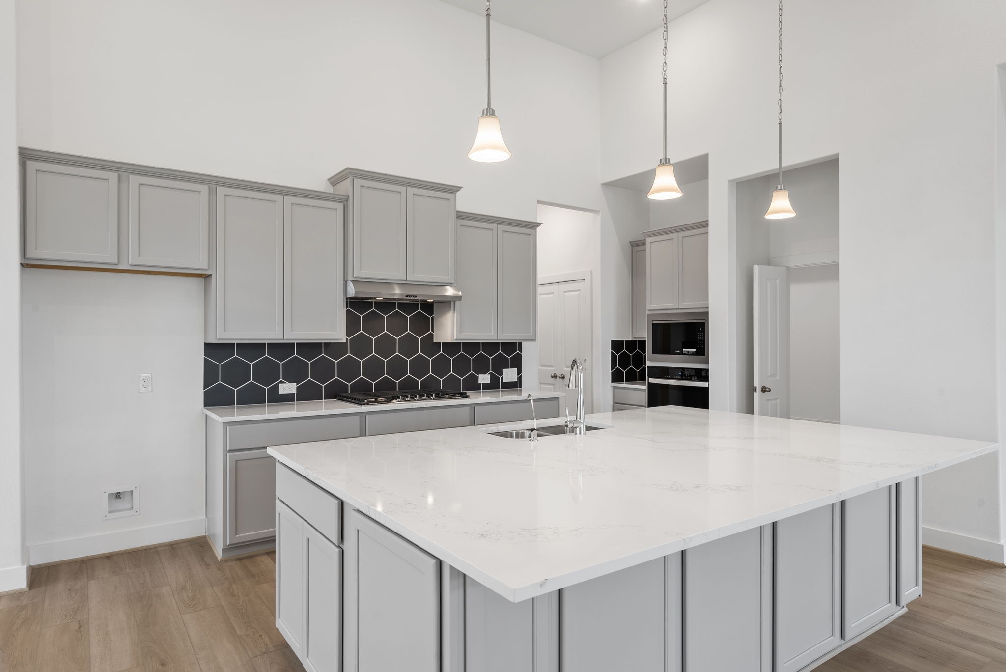 18806 Forested Street Manvel, TX 77578 - Photo 3 of 35 a kitchen with stainless steel appliances a sink and a refrigerator