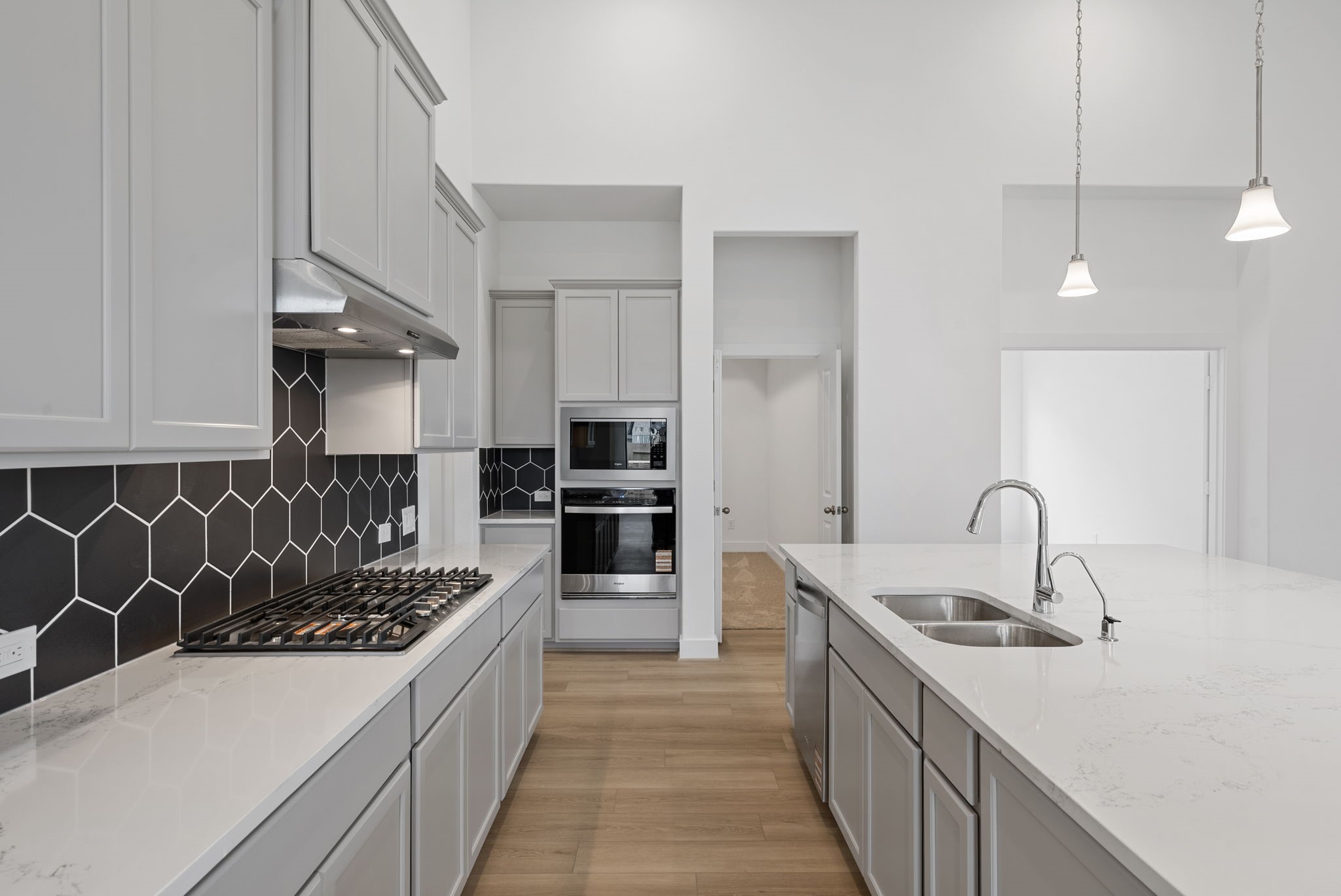 18806 Forested Street Manvel, TX 77578 - Photo 6 of 35 a kitchen with a sink and a stove top oven