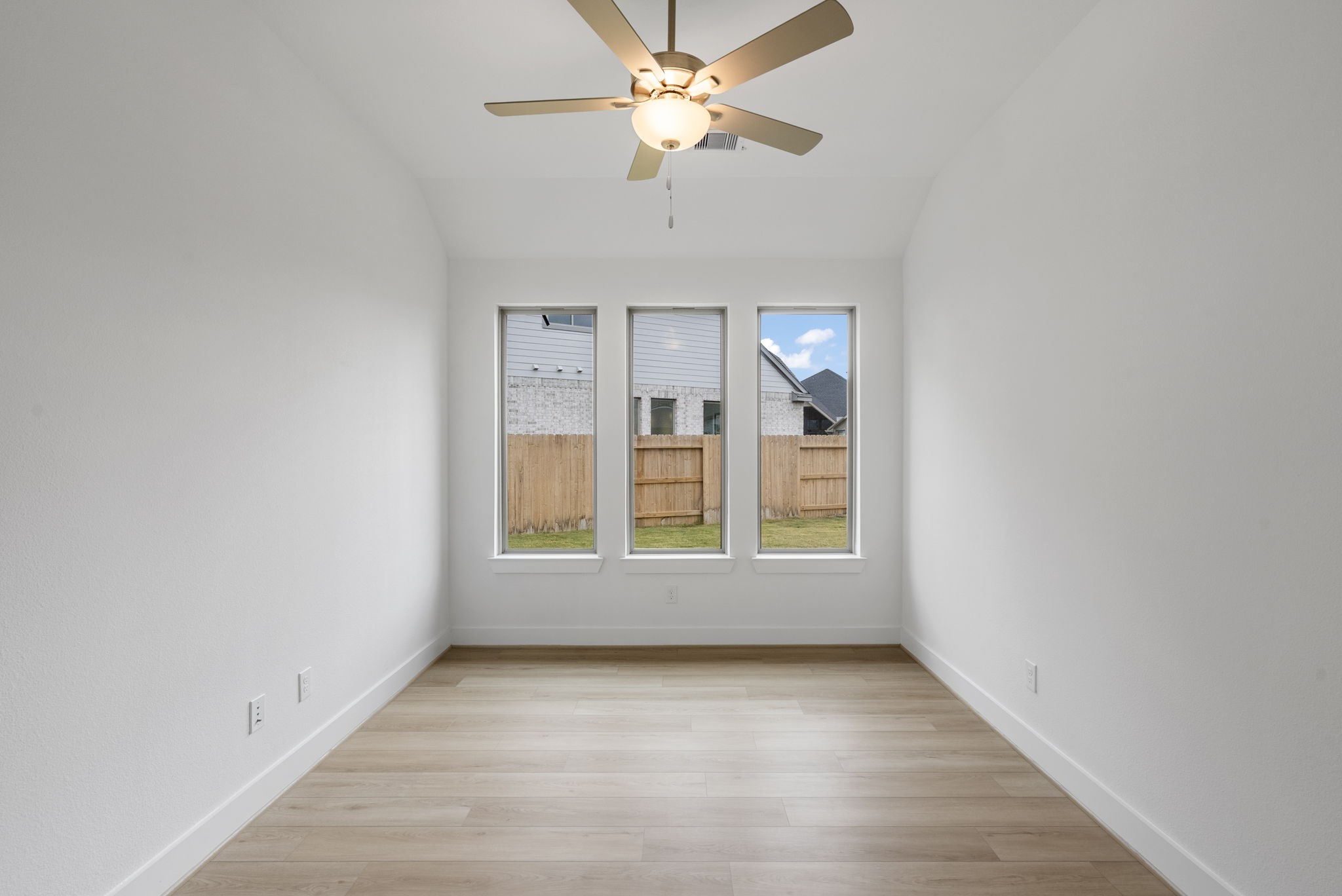 18806 Forested Street Manvel, TX 77578 - Photo 9 of 35 an empty room with chandelier fan and windows