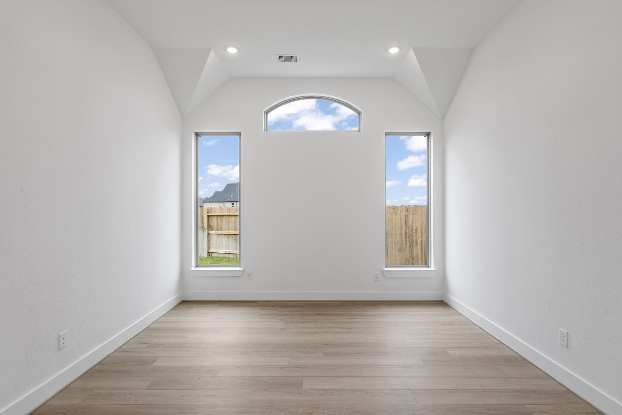18806 Forested Street Manvel, TX 77578 - Photo 10 of 35 an empty room with wooden floor chandelier and windows