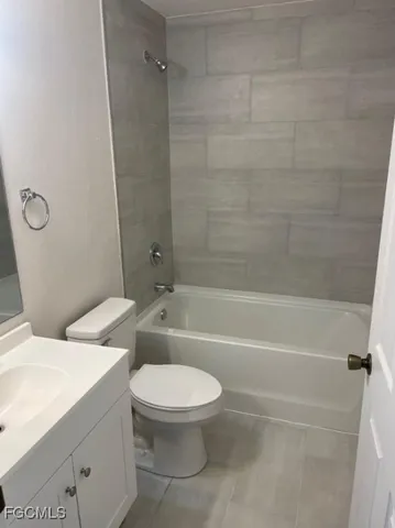 a bathroom with a toilet and a bath tub