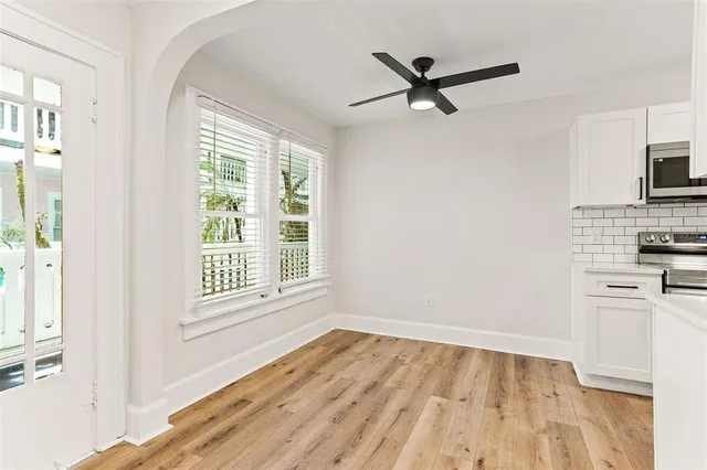 a view of a kitchen with a microwave and a ceiling fan
