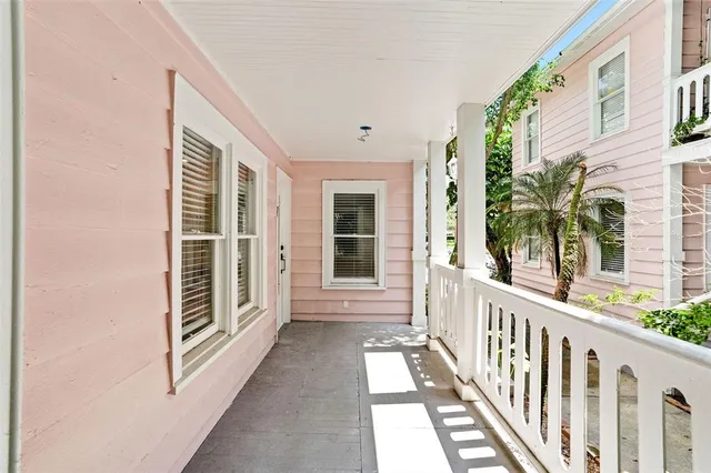 a view of a balcony with wooden floor and fence