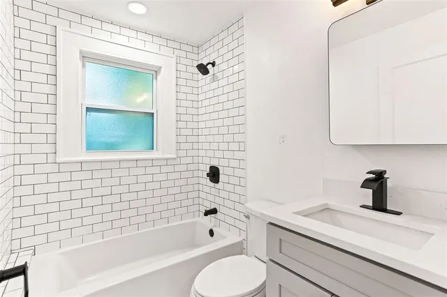 a bathroom with a sink a toilet and bathtub