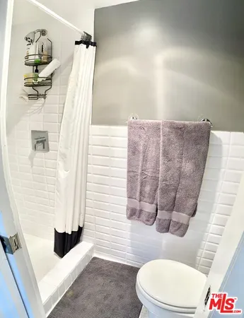 a bathroom with a toilet and shower