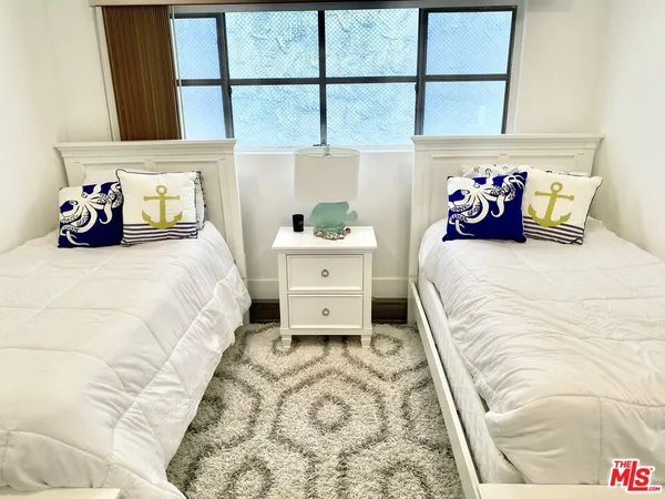 a bedroom with a large bed and a window