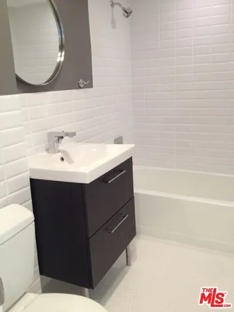 a bathroom with a sink vanity and a mirror