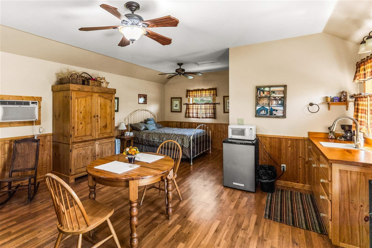 16554 Cocoran Gray Road Groveland, CA 95321 - Photo 31 of 38 Dining room with dark hardwood / wood-style floors, ceiling fan, sink, and lofted ceiling