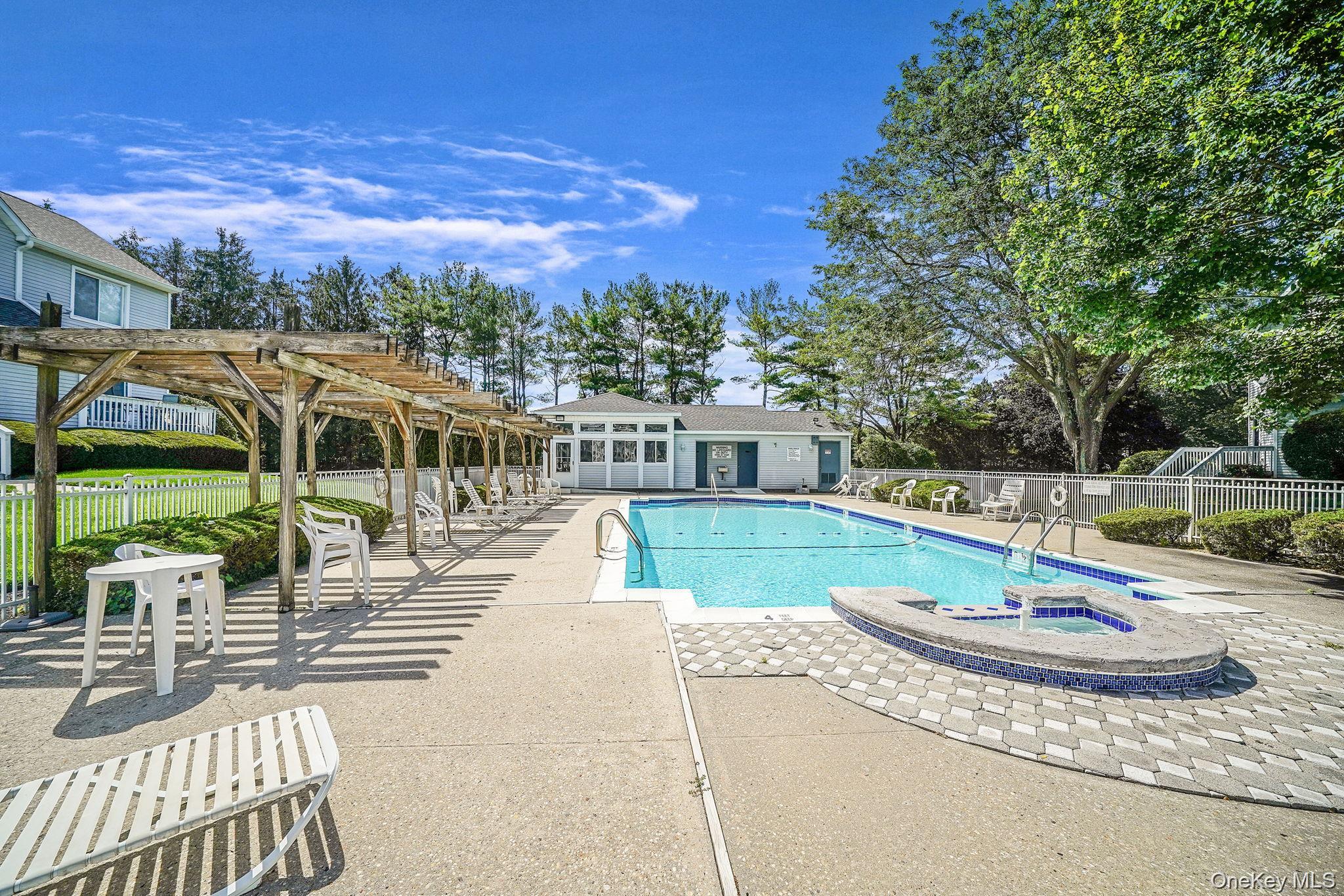 35 Gibbs Road, Unit 22 Coram, NY 11727 - Photo 20 of 20 Community pool featuring a pergola, a patio area, a hot tub, an outbuilding, and an exterior structure