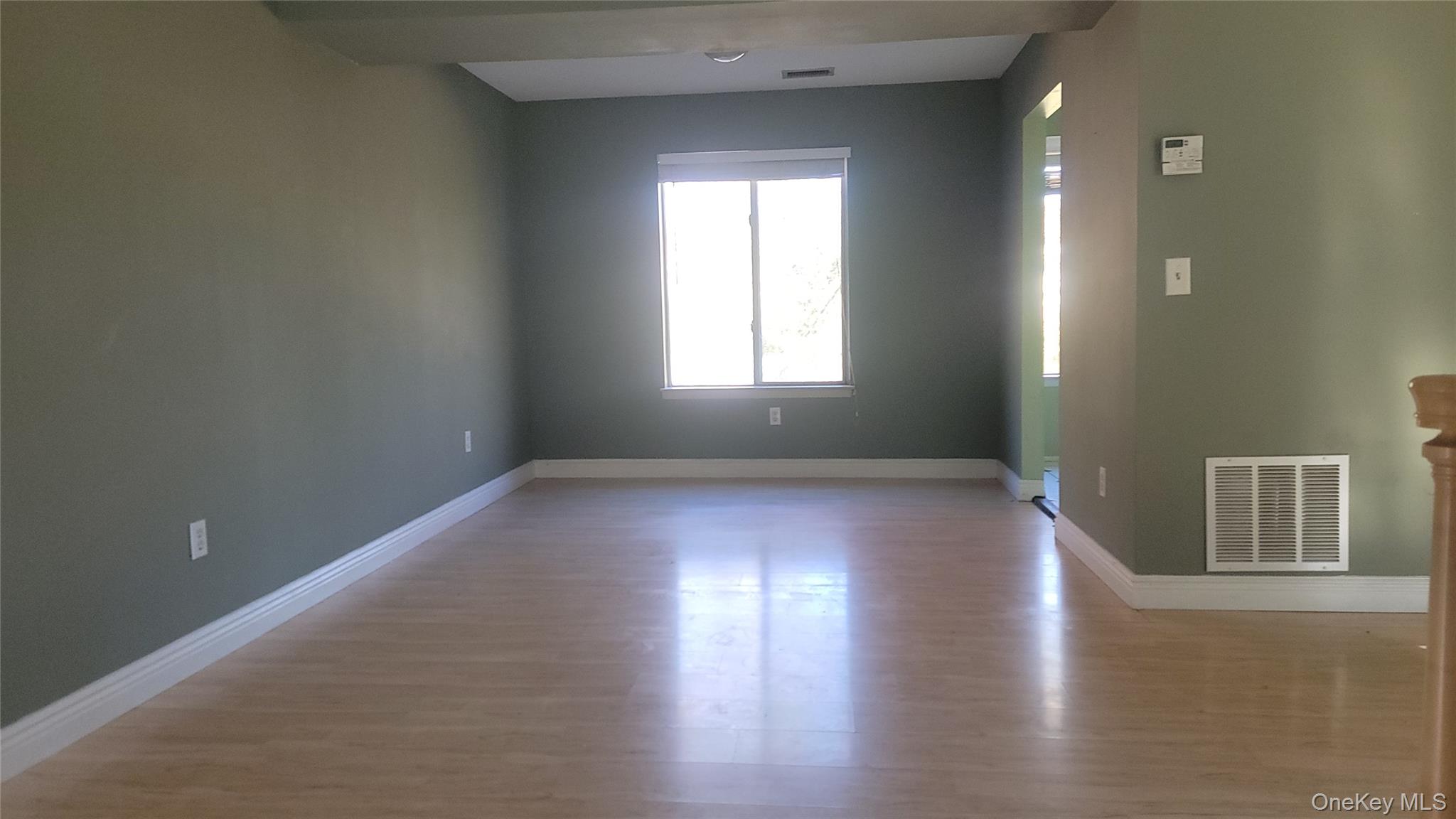 35 Gibbs Road, Unit 22 Coram, NY 11727 - Photo 5 of 20 Unfurnished room featuring baseboards and light wood-style flooring