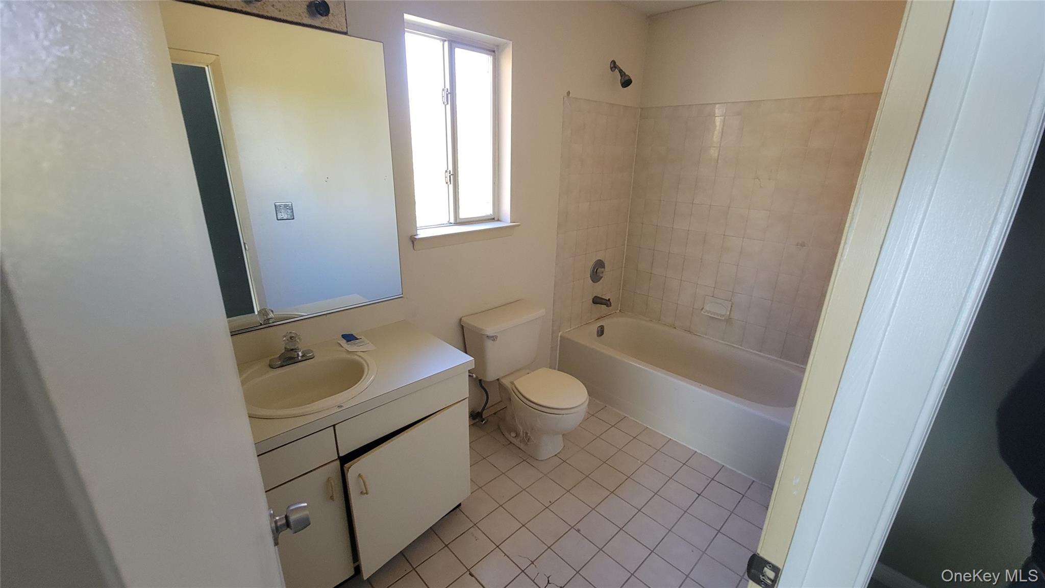 35 Gibbs Road, Unit 22 Coram, NY 11727 - Photo 9 of 20 Bathroom with vanity, light tile patterned floors, and tub / shower combination