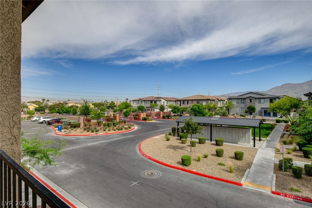7330 North Decatur Boulevard, Unit 6 North Las Vegas, NV 89084 - Photo 19 of 42 A manicured community entrance welcomes residents home, framed by distant mountains and a bright sky.
