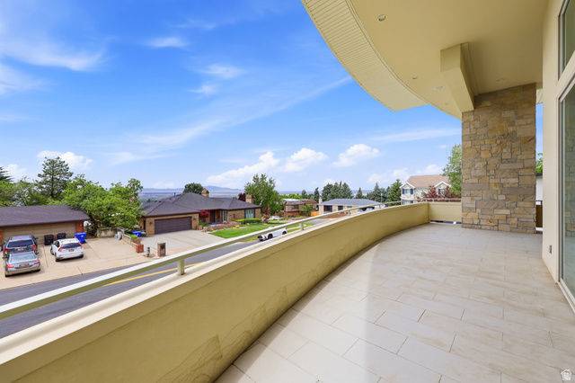 1389 Millbrook Way Bountiful, UT 84010 - Photo 13 of 74 Curved balcony featuring stone veneer column, recessed lighting, and a panoramic mountain landscape