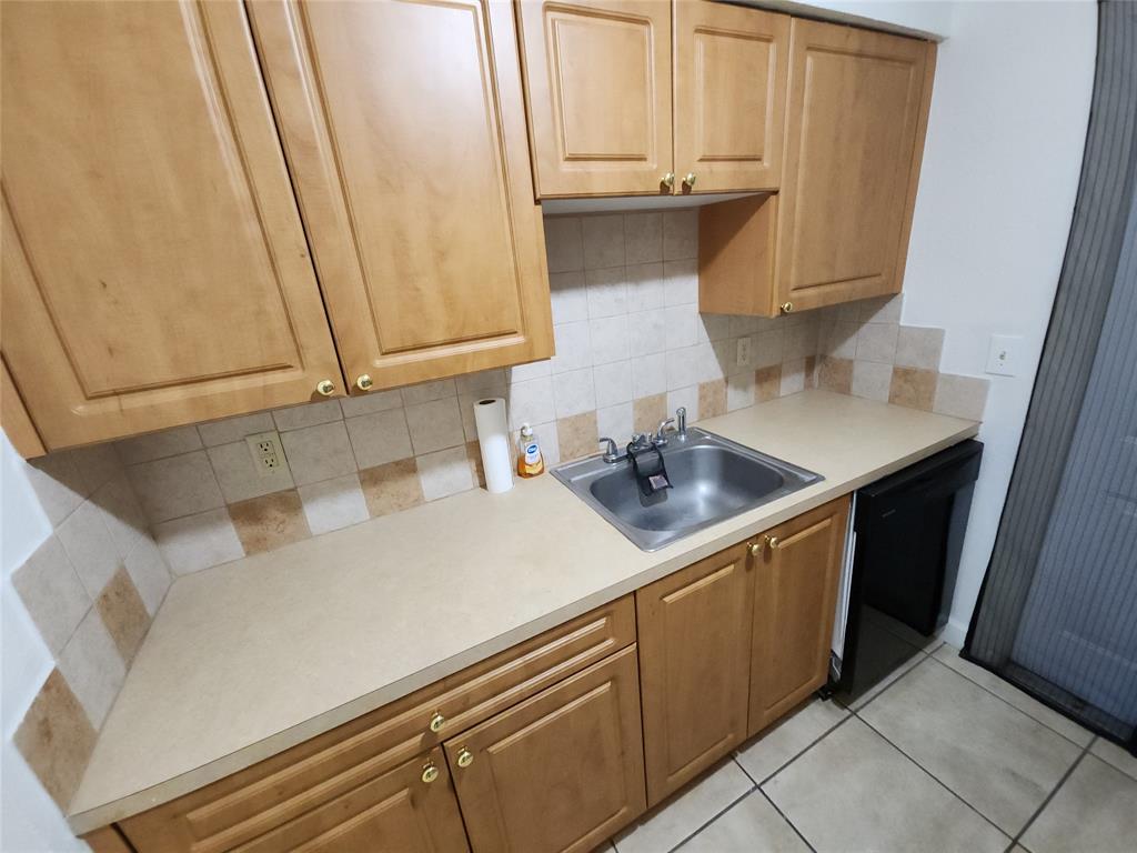2607 Northeast 8th Avenue, Unit 7 Wilton Manors, FL 33334 - Photo 28 of 30 a kitchen with a sink and cabinets