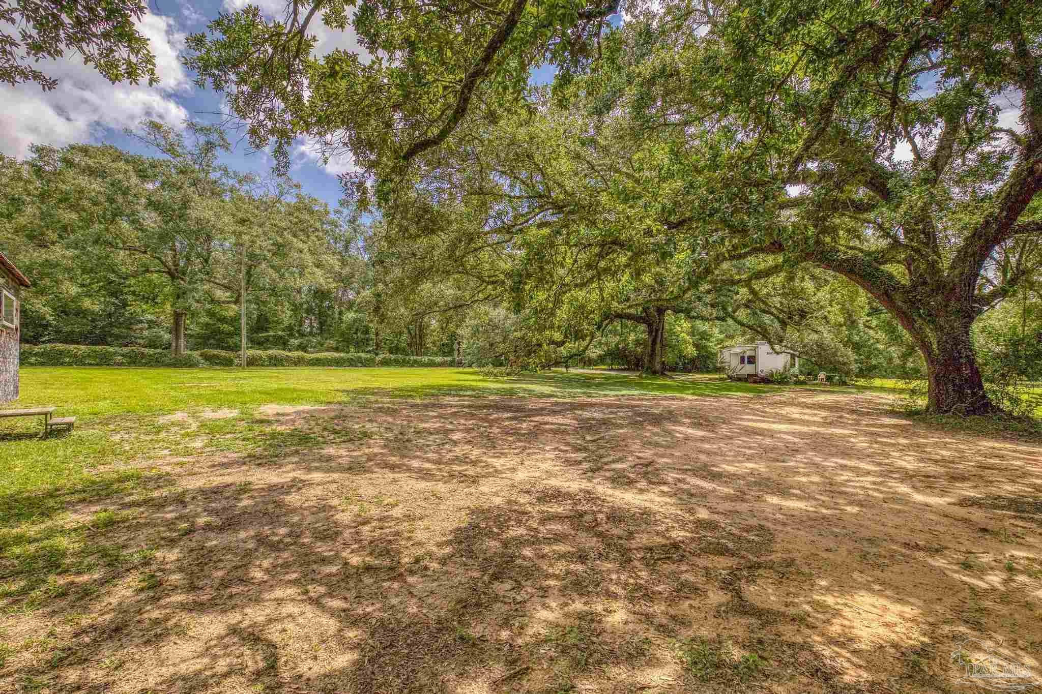 2345 Pompano Street Cantonment, FL 32533 - Photo 7 of 48 a view of an outdoor space and a yard