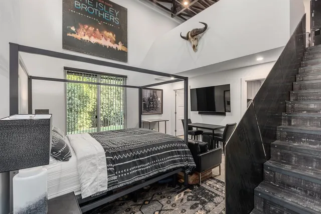 a bed sitting in a bedroom next to a window