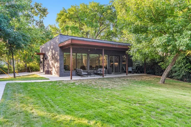 a view of a patio with table and chairs under an umbrella