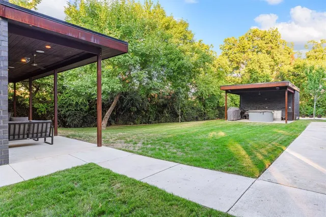 a view of a chair and table in the garden